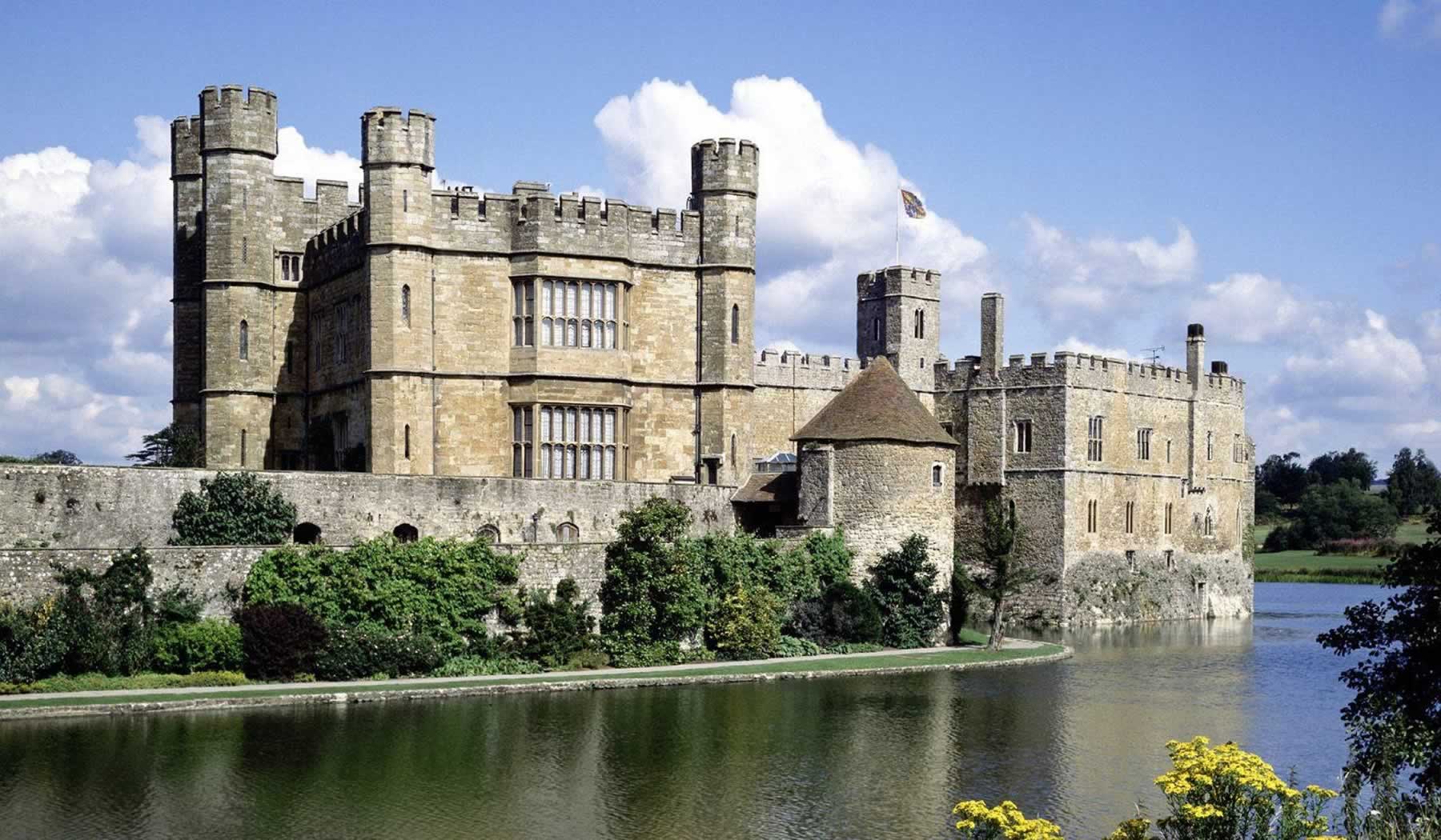 View of a castle sitting on the river