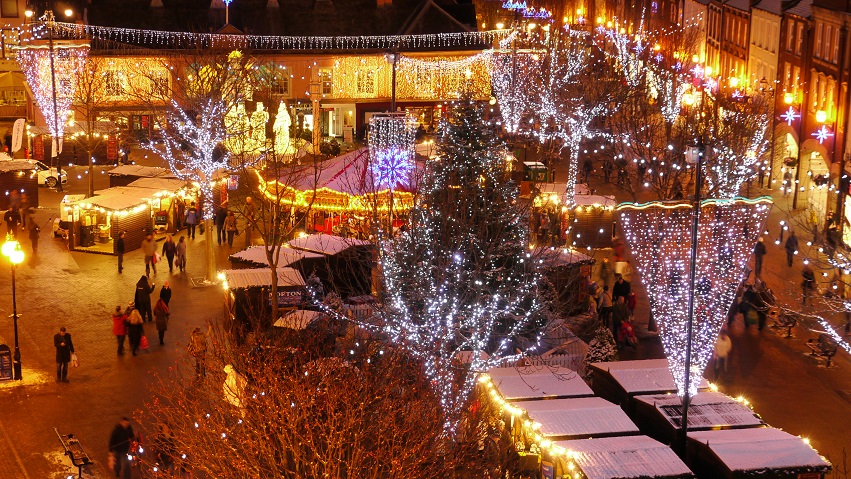 Christmas market at night lit up by Christmas lights