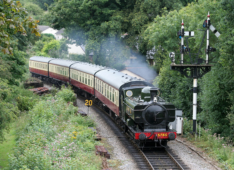 Steam train running along the tracks