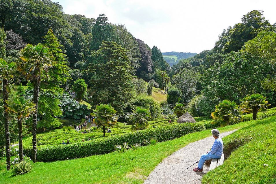 Lady sat on a bench in Glendurgan Garden 