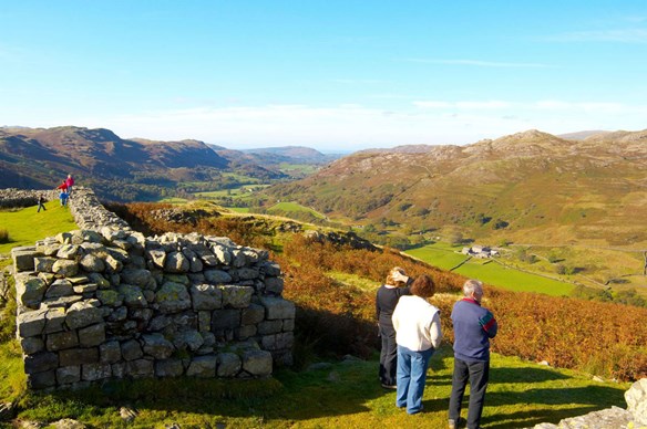 Three people looking at Hardknott Pass