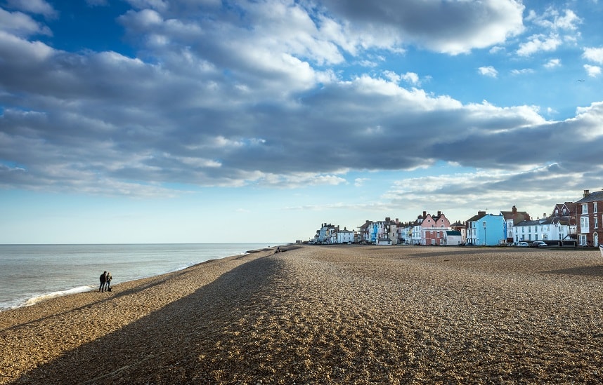 Blue skies and beach huts on the sandy Suffolk coast