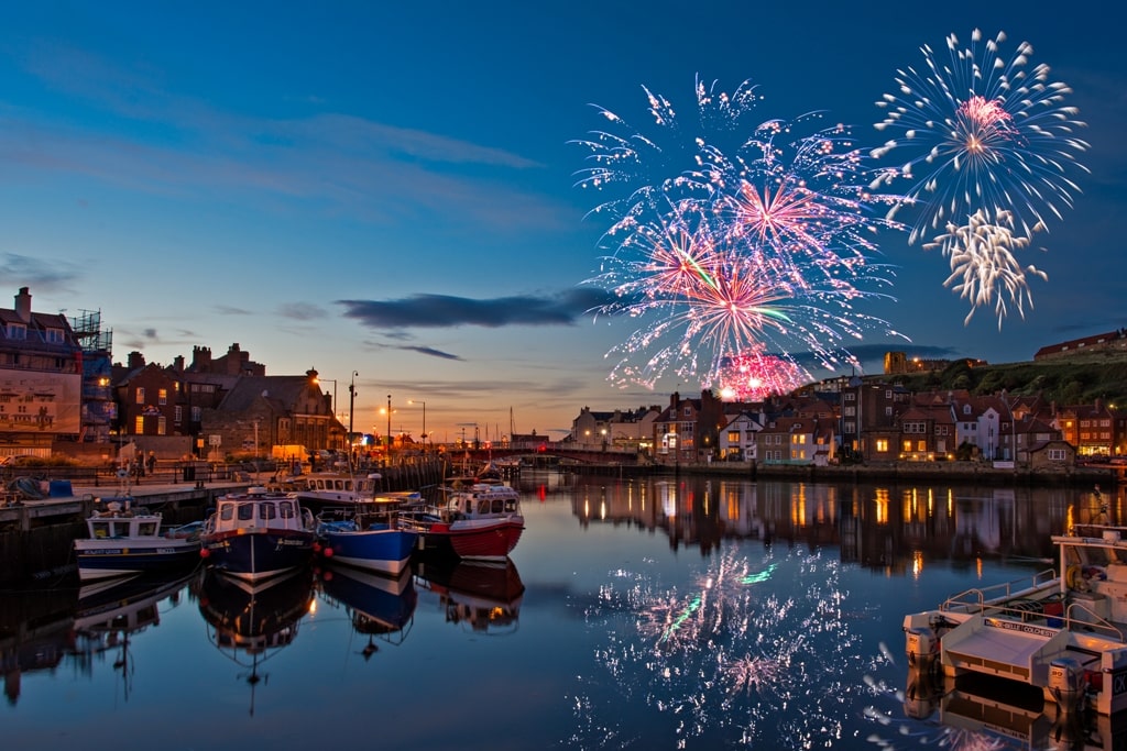 Fireworks and boat on the harbour at Whitby Regatta, Yorkshire