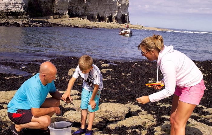 Family rockpooling on the Yorkshire coast