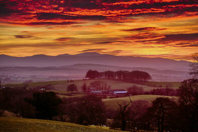 Orange and purple sunset by a holiday cottage