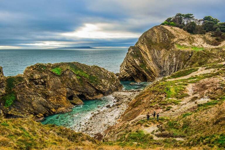 People walking by the Jurassic Coast in Devon 