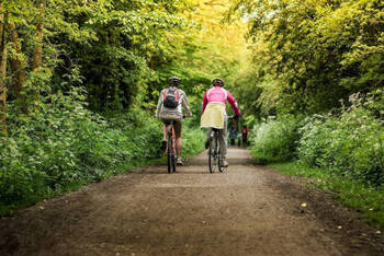 Two people cycling through the Peak District