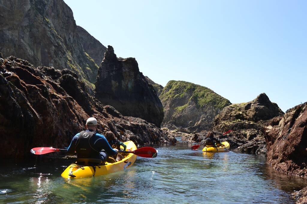 People coastal kayaking in Wales