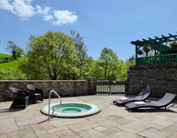 Hot tub in the ground at a holiday cottage