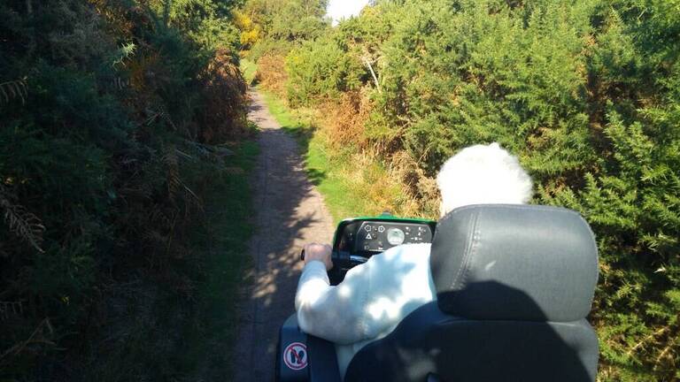 Lady on a scooter in the countryside