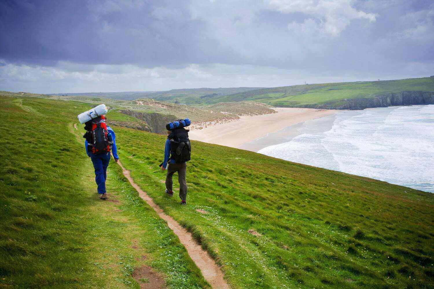 People walking the coastal path with views of the sea