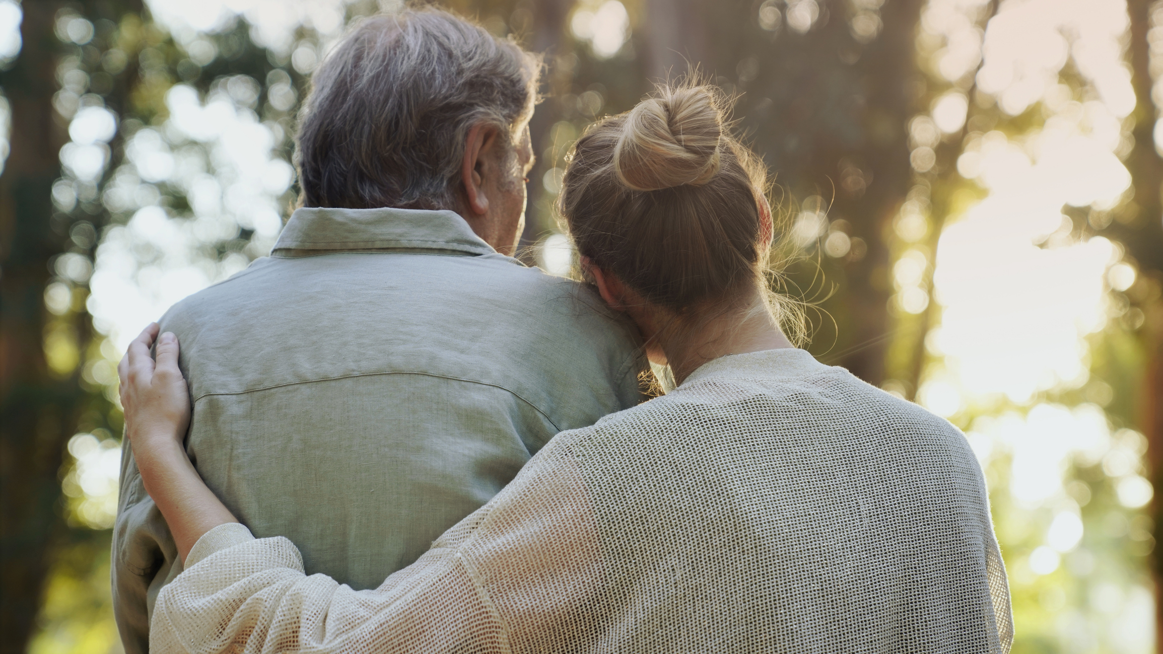 Father and daughter with arms around eachother