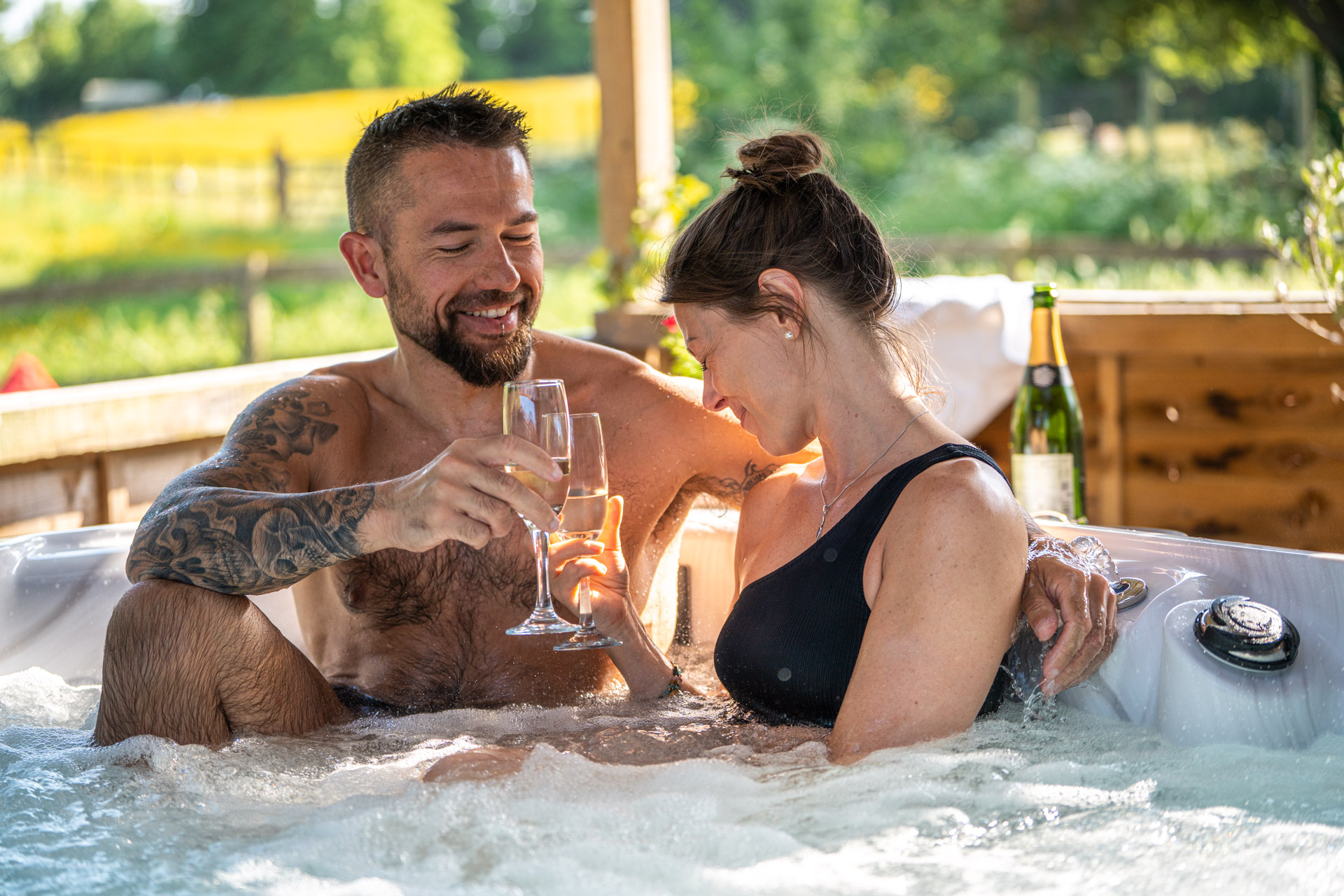Couple in hot tub with champagne